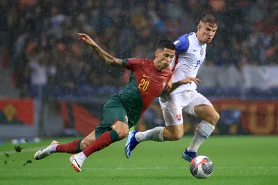 Portugal's Joao Cancelo vies for the ball with Slovakia's Robert Bozenik, right, during the Euro 2024 group J qualifying soccer match between Portugal and Slovakia at the Dragao stadium in Porto, Portugal, Friday, Oct. 13, 2023. (AP Photo/Luis Vieira)
- XEURO2024X