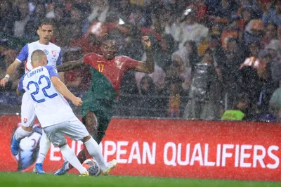 Portugal's Rafael Leao, right, tries to drive the ball past Slovakia's Stanislav Lobotka during the Euro 2024 group J qualifying soccer match between Portugal and Slovakia at the Dragao stadium in Porto, Portugal, Friday, Oct. 13, 2023. (AP Photo/Luis Vieira)
- XEURO2024X
