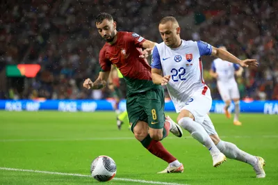 Portugal's Bruno Fernandes vies for the ball with Slovakia's Stanislav Lobotka, right, during the Euro 2024 group J qualifying soccer match between Portugal and Slovakia at the Dragao stadium in Porto, Portugal, Friday, Oct. 13, 2023. (AP Photo/Luis Vieira)
- XEURO2024X